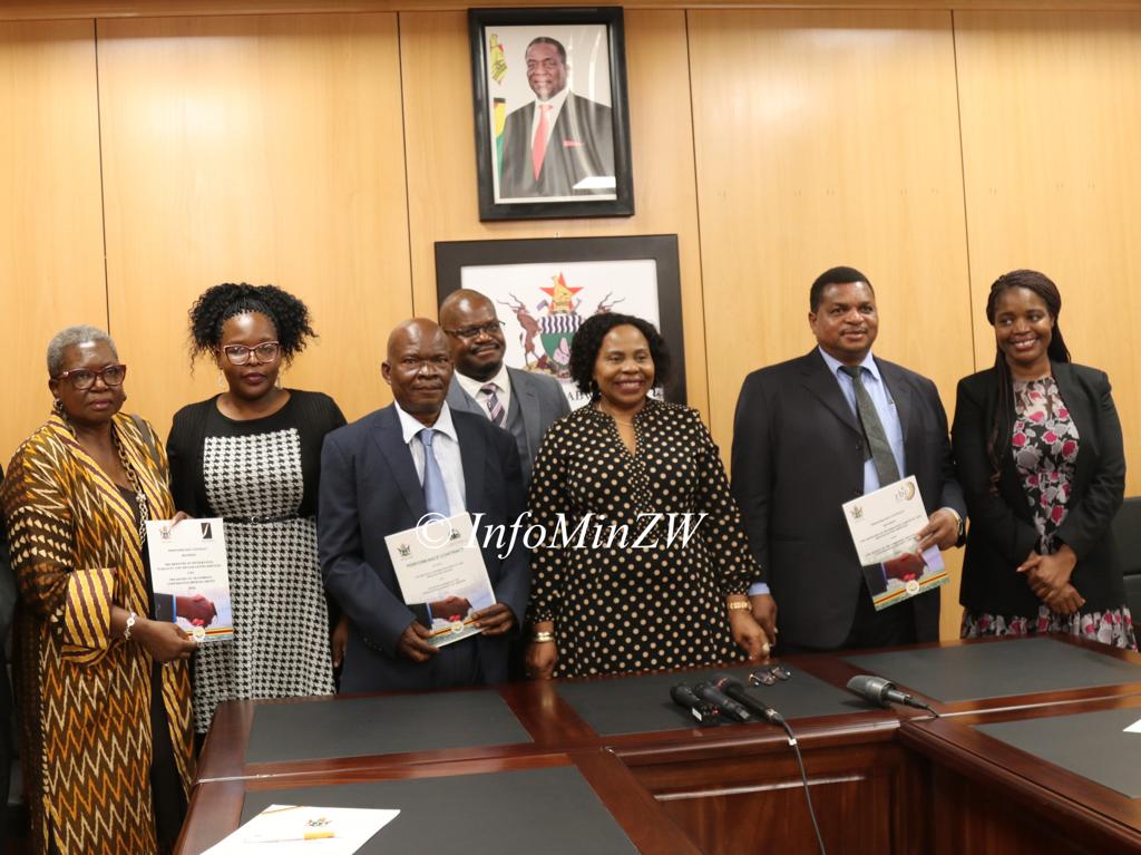 Information minister Mutsvangwa with board chairpersons after signing performance contracts